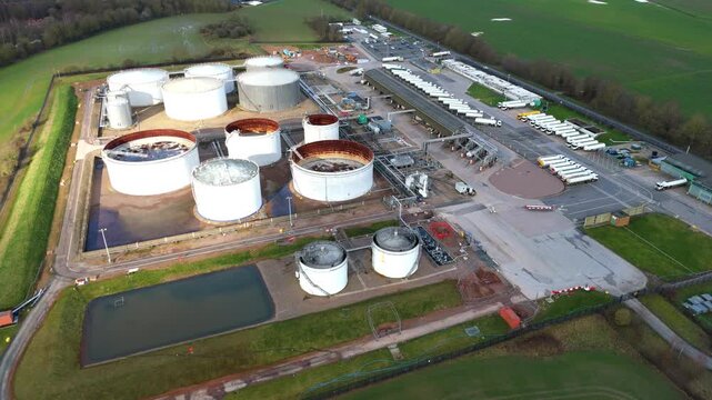 Aerial drone view of a massive UK energy storage facility, featuring vast rows of oil tanks and gas reserves for national fuel security.