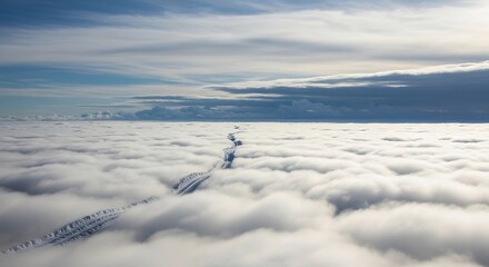 Majestic mountain peak rising above the clouds with a rugged trail to the summit