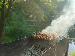 Outdoor barbecue. Meat on a grill over hot coals