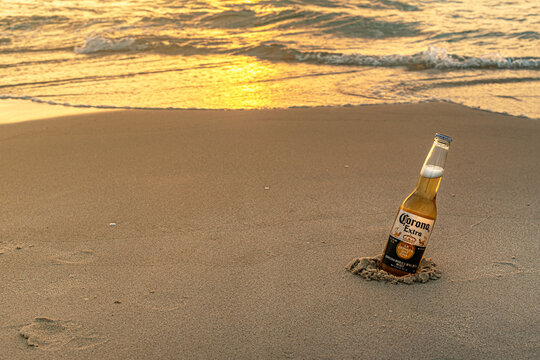 Ashdod, Israel &ndash; July 07, 2023: Bottle of Corona Extra beer on sandy beach at sunset
