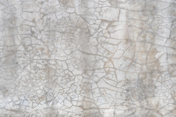 Fototapeta premium Cracked gray natural concrete wall texture. Close-up of cracked gray background.