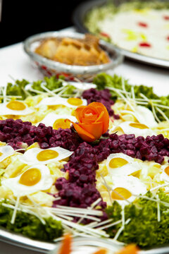 Beautifully Decorated Salad with Quail Eggs and Beetroot, Garnished with an Orange Rose