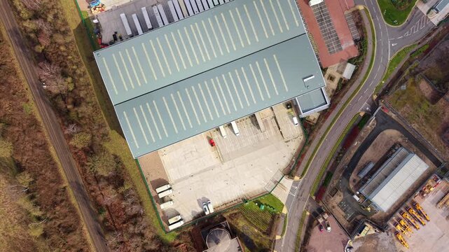 Industrial drone perspective of a busy freight distribution centre, illustrating the precision of loading bay operations and HGV logistics.
