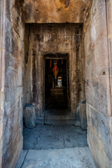 Obraz premium Stone doorway framing Buddha statue in Angkor Wat temple