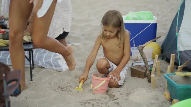 People gather on the sand for a lively beach picnic, surrounded by snacks, fruits, and playful moments. The image captures summer leisure, friendship, and carefree coastal fun