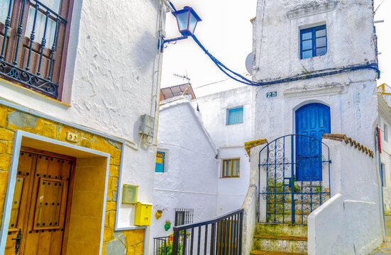 Charming narrow street with whitewashed houses and a bright blue door in a Mediterranean village