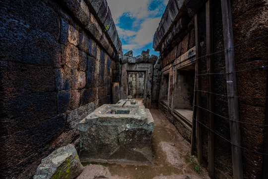Ancient stone corridor and altar in Prasat Neang Khmau temple ruins