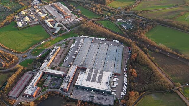 Aerial view of a huge logistics distribution centre in Atherton Greater Manchester with HGVs lined up at loading bays for export UK