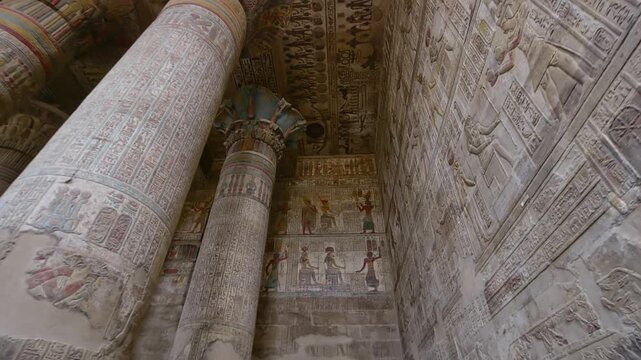 Egypt. Esna temple hypostyle hall with massive painted columns and colorful hieroglyphic reliefs on ceiling in Egypt, ancient Roman-era architecture with preserved pigments and carvings.