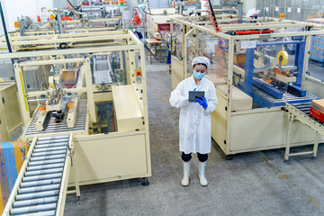 Worker monitoring production line in modern manufacturing facility