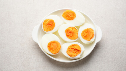 Hard boiled eggs peeled and cut in plate