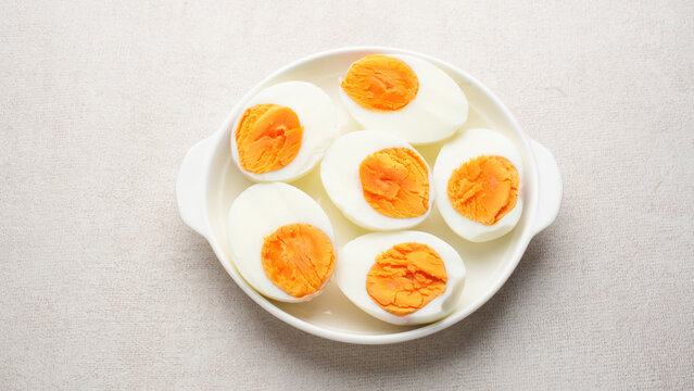 Hard boiled eggs peeled and cut in plate