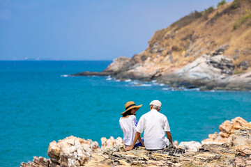 Senior couple enjoy their vacation at sea beach in summer for healthy relationship and happy loving marriage life in retirement years