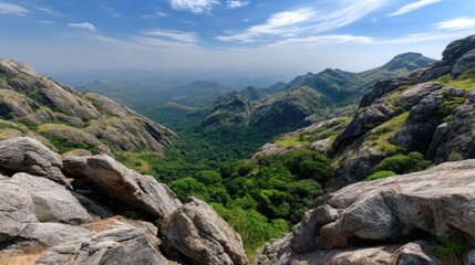 Fototapeta premium Ancient fort stands in background of green mountains with rocky landscape and trees under clear sky during sunny daylight