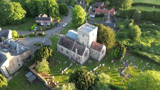 Close Aerial Orbit Around English Parish Church at Golden Hour Barton Seagrave Northamptonshire