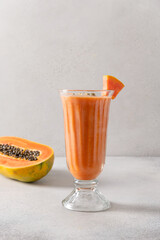 Fototapeta premium Papaya lassi in glass on gray background.