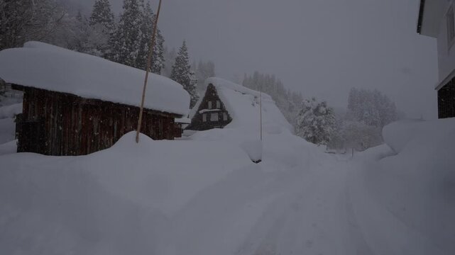 Walking in heavy snow through traditional Japanese village, Ainokura - Toyama, Japan