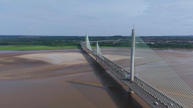 Liverpool, Merseyside, UK, June 19, 2025; Aerial 4K video footage of the Mersey Gateway toll bridge with stunning views over the River Mersey, Liverpool, UK.