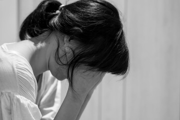 Fototapeta premium Monochrome picture, Depression and mental illness. Asian woman disappointed, sad after receiving bad news. Stressed girl confused with unhappy problems, cry and worry about unexpected pregnancy.