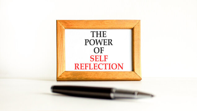 Self reflection symbol. Concept words The power of self reflection on beautiful wooden picture frame. Beautiful white background. Business the power of self reflection concept. Copy space.