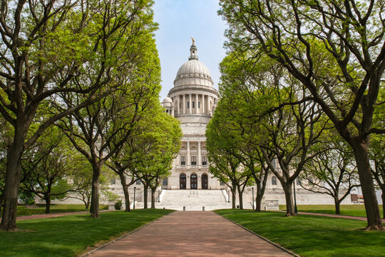 Front view of the Rhode Island State House framed by trees