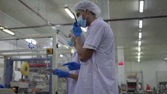 Collaboration in production manufacturing facility team meeting professional environment indoor setting technical discussion