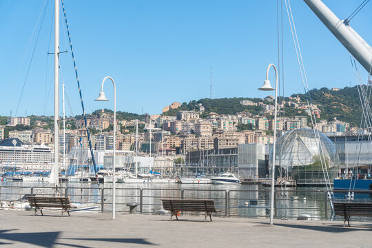 Genua, Italy, 07.08.26, Waterfront promenade with marina and city buildings in Genoa. Sunny Mediterranean atmosphere and coastal tourism concept.