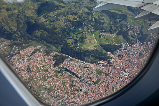 aerial perspective,captured moments before landing at Alejandro Velasco Astete International Airport, offers a first glimpse of the rugged beauty and agricultural heritage surrounding Cusco, Peru. 