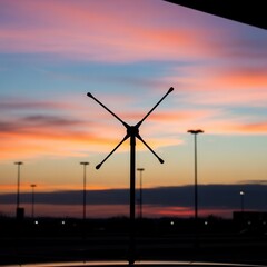 Obraz premium Dramatic Sunset Silhouette With Antenna Array and Evening Sky, Urban Landscape Background