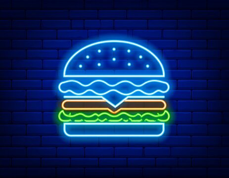 A vibrant neon sign showcases a stylized burger. It's glowing against a dark blue brick wall, a common fast-food image