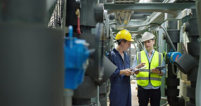 Professional engineers are inspecting mechanical valves and pipeline systems in a modern industrial factory, focusing on facility safety compliance and operational efficiency.