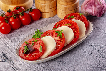 Italian caprese salad with mozzarella, tomato and basil