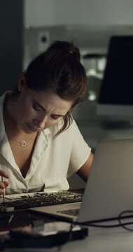 Frustrated, woman or technician with laptop for repair, fixing electrical components or wrong tools. Female person, IT service or night with bad circuit board on computer for troubleshooting hardware