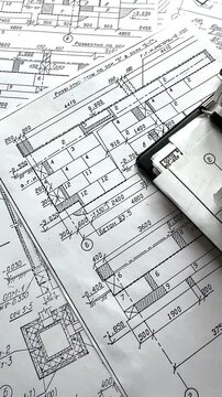 Architecture blueprints with rolled plans, compass and clipboard on desk, construction documentation and engineering design workflow, BIM planning and project management concept, copy space.