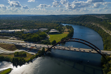 Naklejka premium Aerial View of Pennybacker Bridge and the Colorado River With Cumulus Clouds in Austin Texas