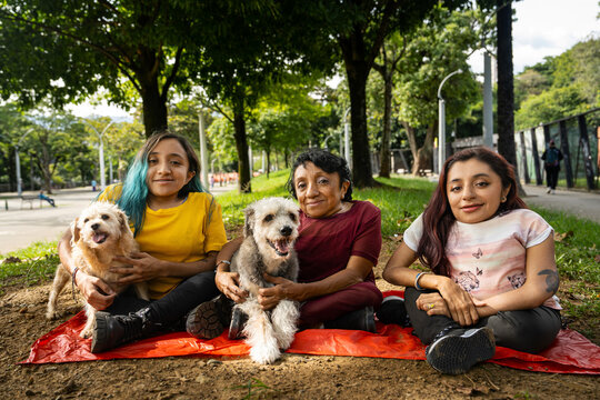 Small group of women with osteogenesis imperfecta and dwarfism in a public park with their dogs