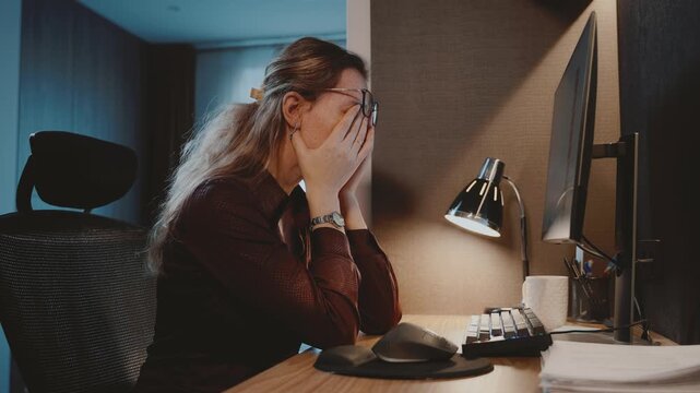Tired workaholic woman with eye strain working at computer. Person eyes rubbing in stress work pc job late overtime. upset face girl worker overloaded digital fatigue long hours at desk. mental health