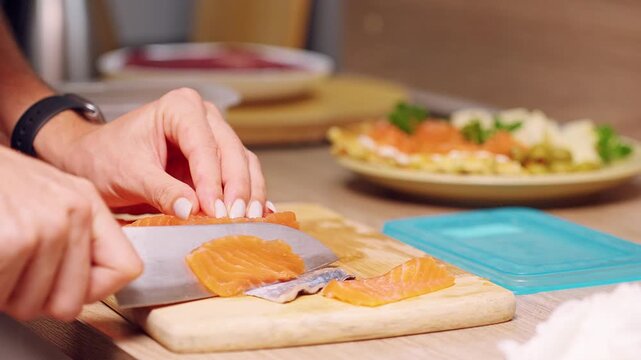 Female Hands Slicing Fresh Salmon Fillet On Wooden Cutting Board, Seafood Preparation In Home Kitchen