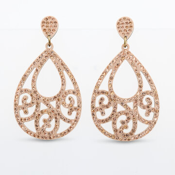 A pair of rose gold teardrop earrings adorned with sparkling crystals on a white background