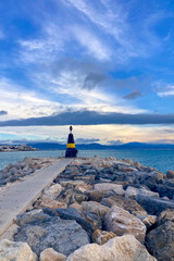 Fototapeta premium Taking a relaxing walk between moored yachts in the vibrant port of Benalmadena, Spain, surrounded by coastal charm and maritime elegance.