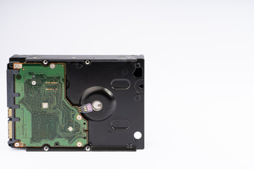 Obraz premium Underside of a Modern Hard Disk Drive with Green Circuit Board