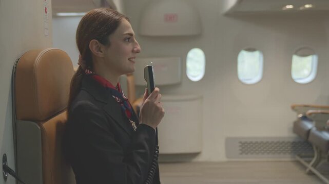 Aircraft staff is announcing information to passengers on airplane in flight audio system. travel and business airline concept. air hostess Important announcement. plane taking off.