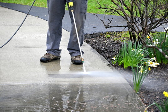 man cleans path. Pearson uses power washer, spring cleaning. 