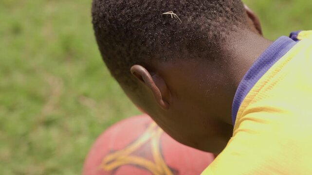 Young viewer observes. Teenager attentively views ongoing sport. Youthful spectator intently observes live athletic event. Young observer carefully follows game happening outside in real time