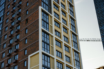 Fototapeta premium Modern residential building with large windows and contrasting facade design