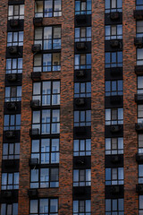 Obraz premium Apartment building facade with air conditioning units and brick exterior