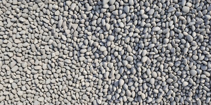 A high-angle view of numerous small gray pebbles densely packed together resembling a textured surface or pattern