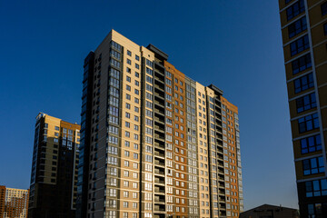Fototapeta premium Modern residential apartment buildings against clear blue sky