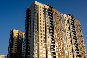 Fototapeta premium Modern residential apartment buildings against clear blue sky