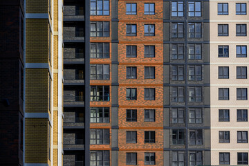 Fototapeta premium Modern apartment building facade with varied brick and window designs